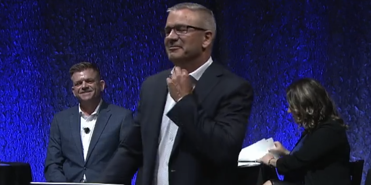 A screenshot of UCP leadership candidate Travis Toews nervously adjusts the tie he’s not wearing during last night’s candidates’ debate.