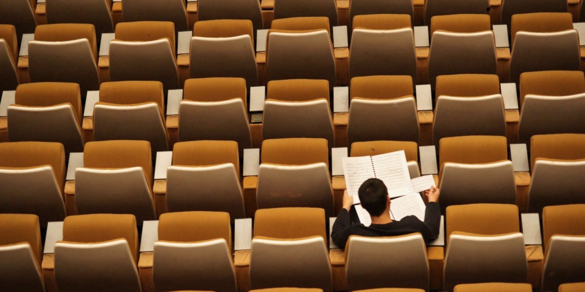 Photo of a student in an auditorium.