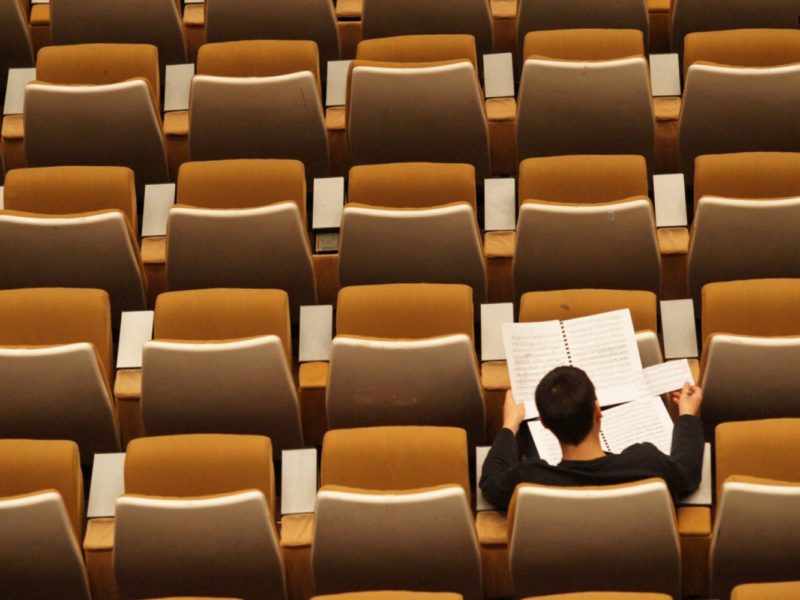 Photo of a student in an auditorium.