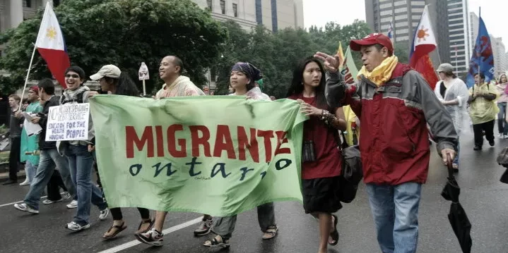 A photo of members of Migrante Ontario marching for migrant worker rights.