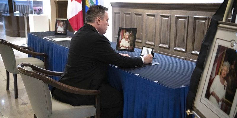 A photo of Jason Kenney as he signs the book of condolence at the McDougall Centre in Calgary on Sept. 8, the day of the Queen’s death.