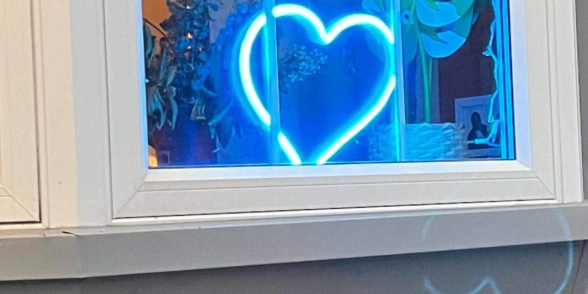 A photo of a neon blue heart.
