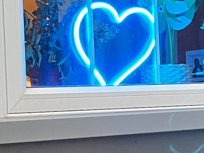 A photo of a neon blue heart.