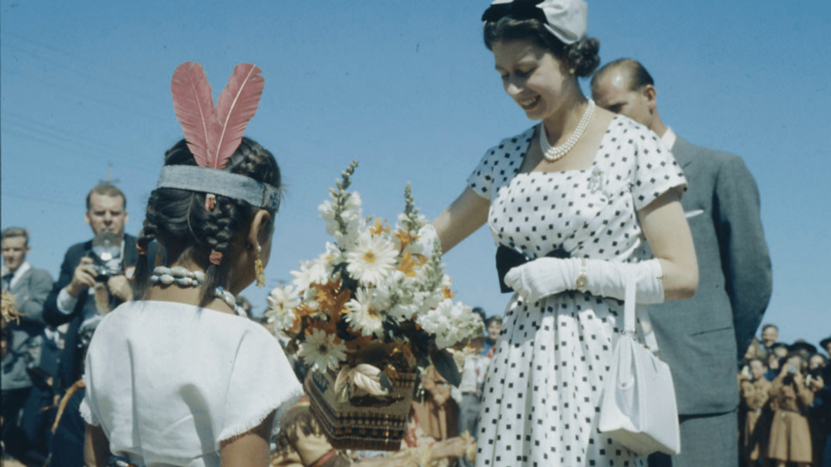 A photo of Queen Elizabeth and an Indigenous small girl.