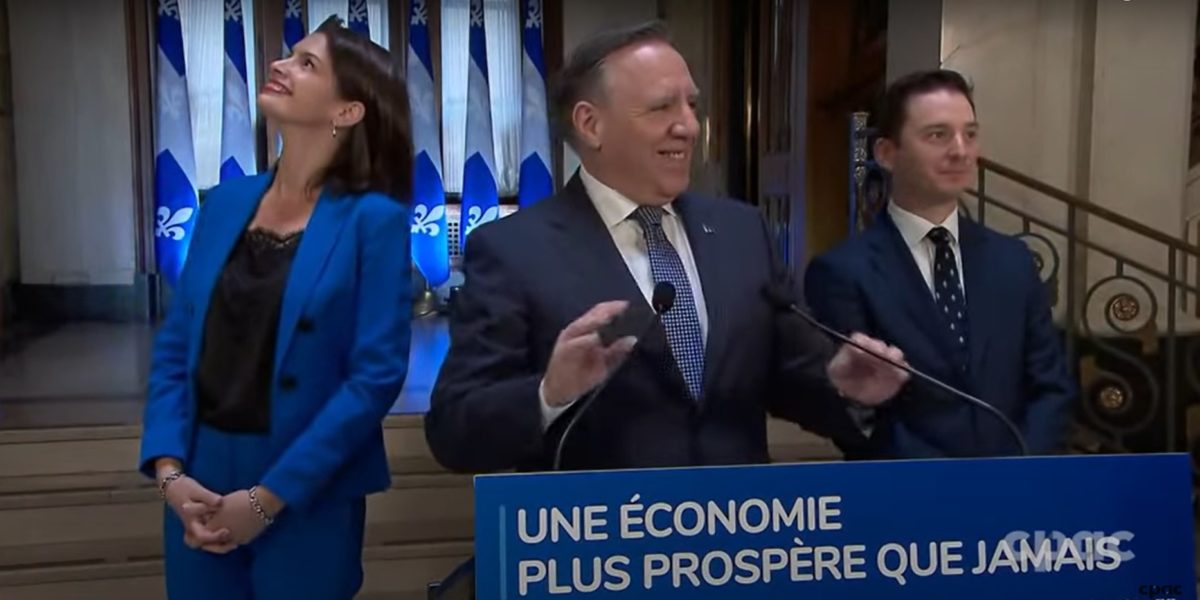 Francois Legault, pictured in the centre, announcing the end of the legislative session on June 10.