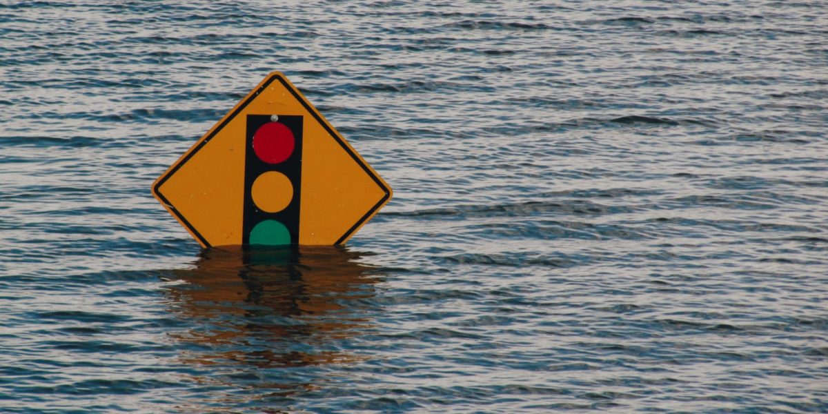 A photo of a nearly submerged street sign in Davenport, Iowa during a flood.