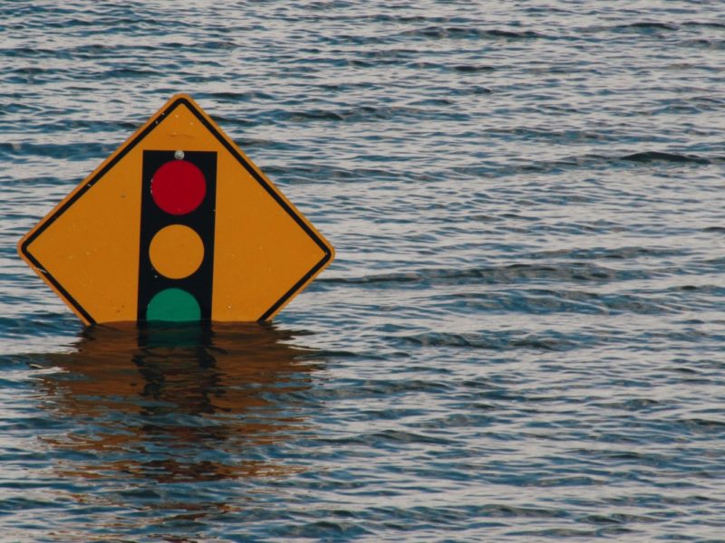 A photo of a nearly submerged street sign in Davenport, Iowa during a flood.