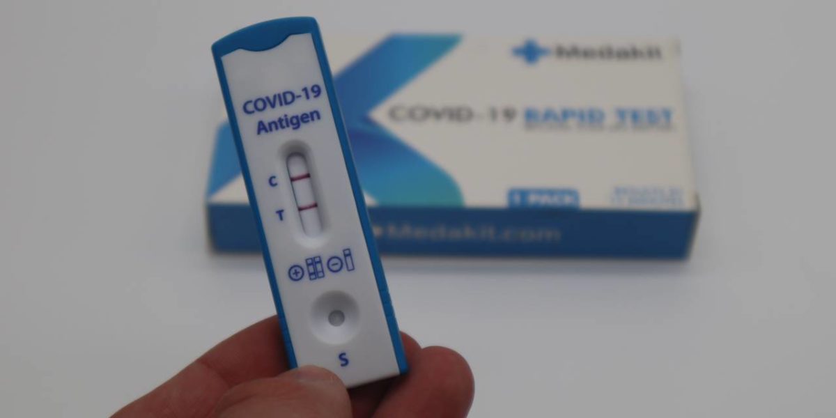 A photo of a positive COVID-19 rapid test.