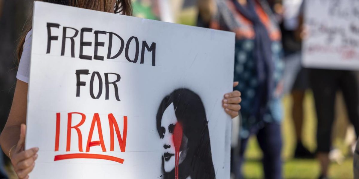 A photo of a woman participating in a solidarity protest for the women in Iran in Santa Barbara, CA, on October 1, 2022.