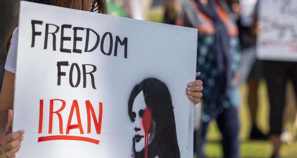 A photo of a woman participating in a solidarity protest for the women in Iran in Santa Barbara, CA, on October 1, 2022.