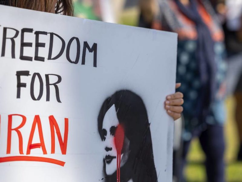 A photo of a woman participating in a solidarity protest for the women in Iran in Santa Barbara, CA, on October 1, 2022.
