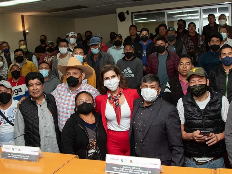 Migrant Workers Representation Pilot with many Mexican workers and trade unionists standing in an immigration office wearing masks