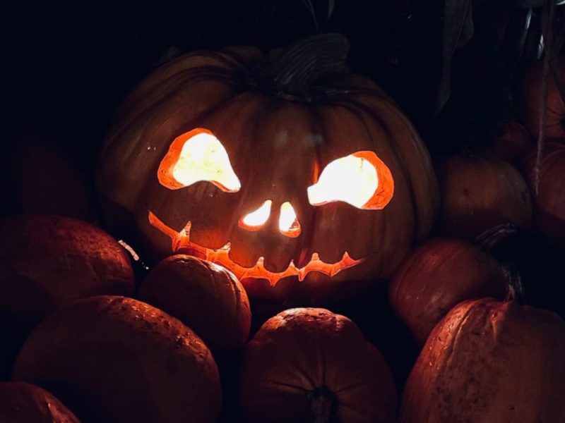 A photo of a jack-o-lantern with a scary face carved into it.