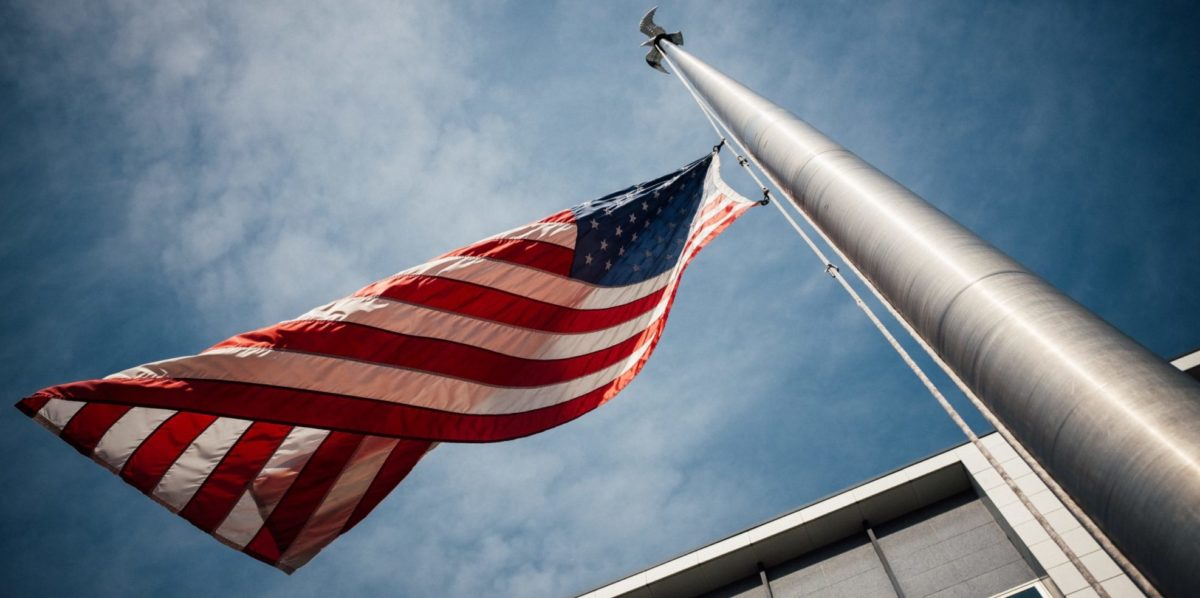 A photo of the USA flag blowing in the wind.