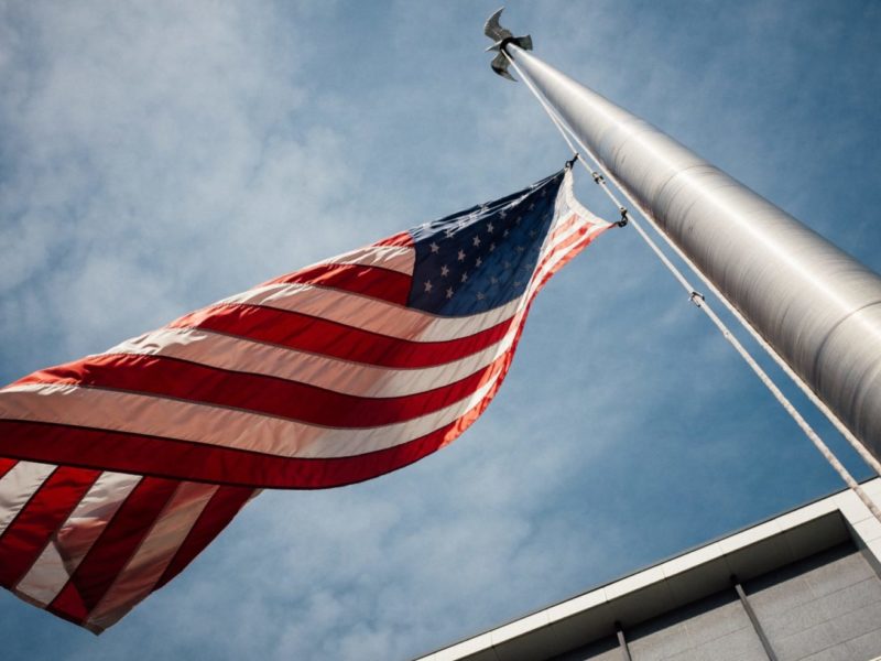 A photo of the USA flag blowing in the wind.