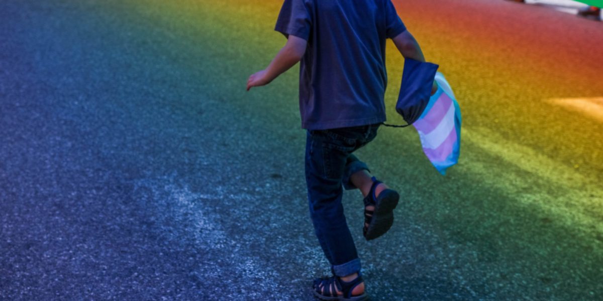 kid running with rainbow flag