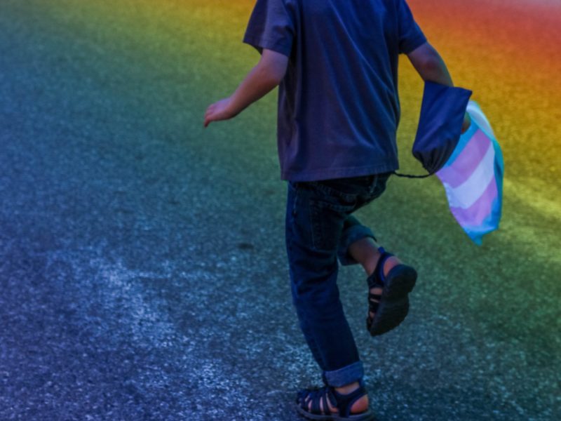 kid running with rainbow flag