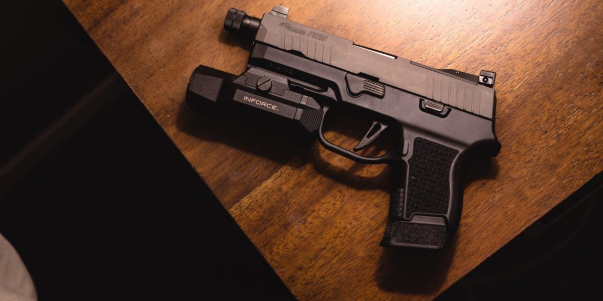 A photo of a handgun sitting on a table.