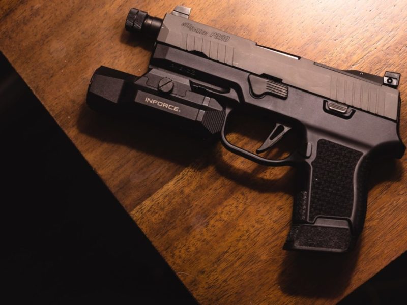 A photo of a handgun sitting on a table.