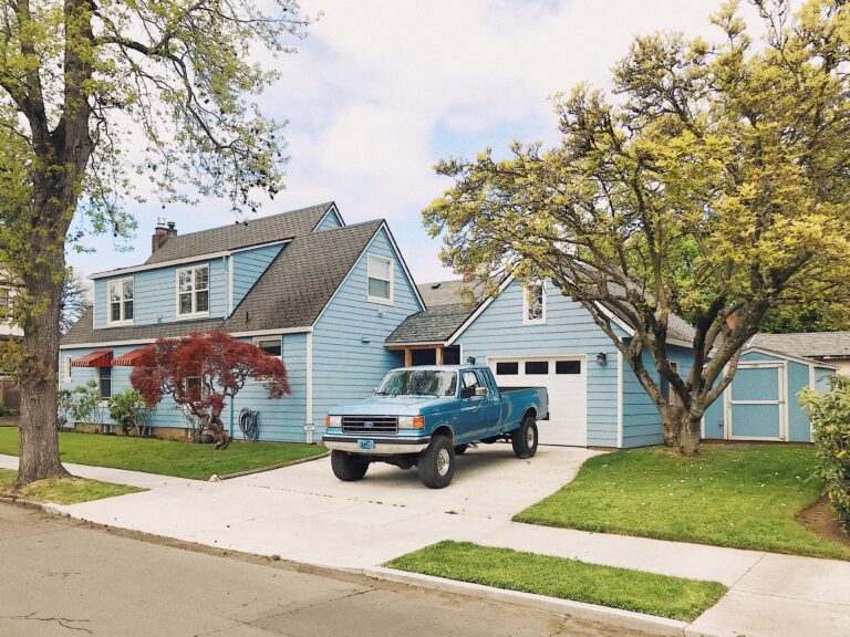 American Dream photo of a house with a pickup truck in the driveway.