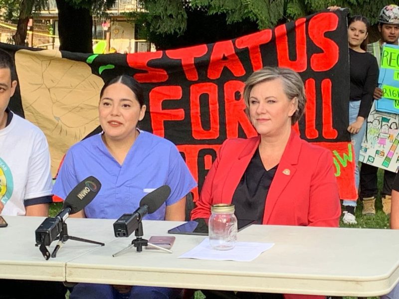 An image of Sanctuary Health member Omar Chu, healthcare worker Claudia Zamorano, HEU President Barb Nederpel and Executive Director of Watari Counselling and Support Services Society Ingrid Mendez speak at a press conference to stop Zamorano's deportation.