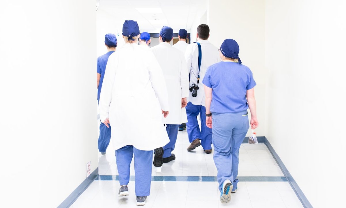 An image of a group healthcare workers walking down a hall