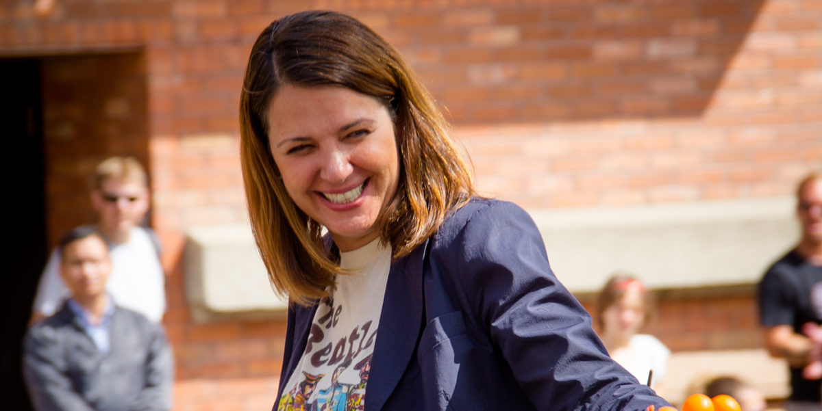 Danielle Smith smiling and waving to supporters in Alberta.