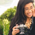 Kiah Lucero smiling and holding a camera.