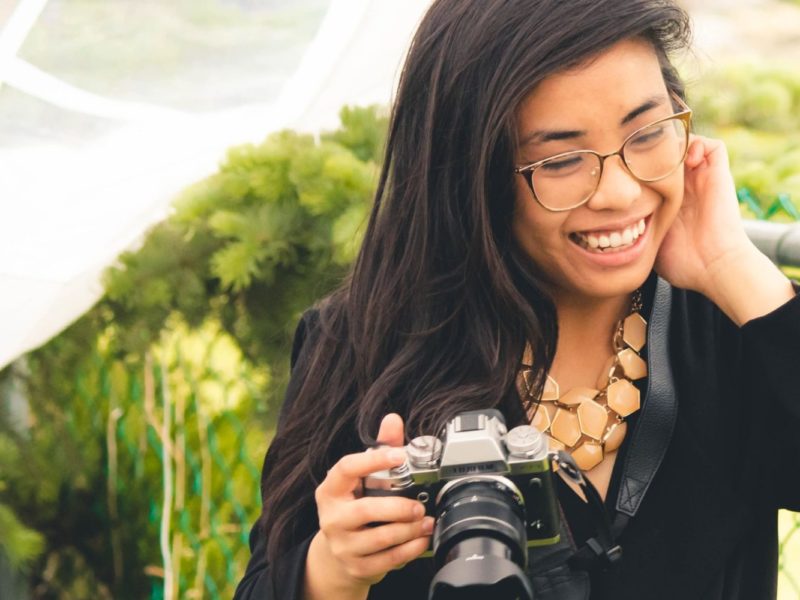 Kiah Lucero smiling and holding a camera.