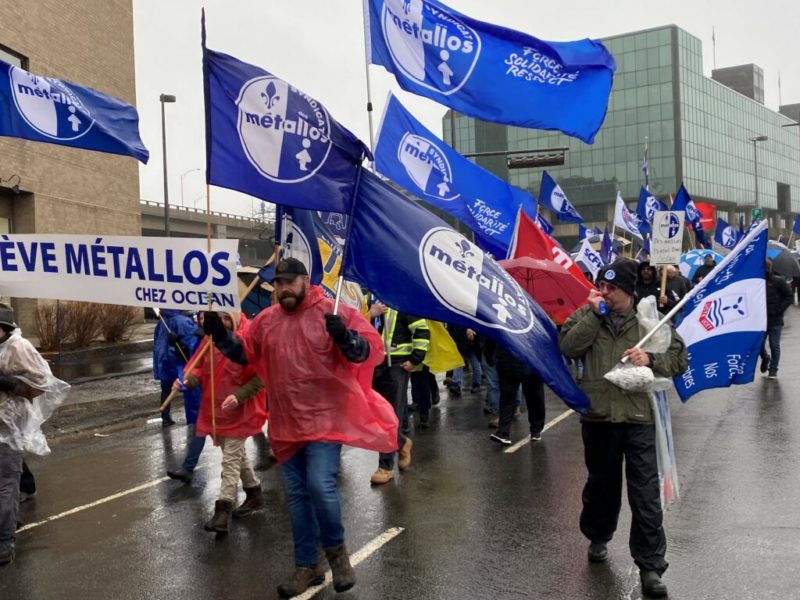 An image of union activists marching in the street in Quebec City.