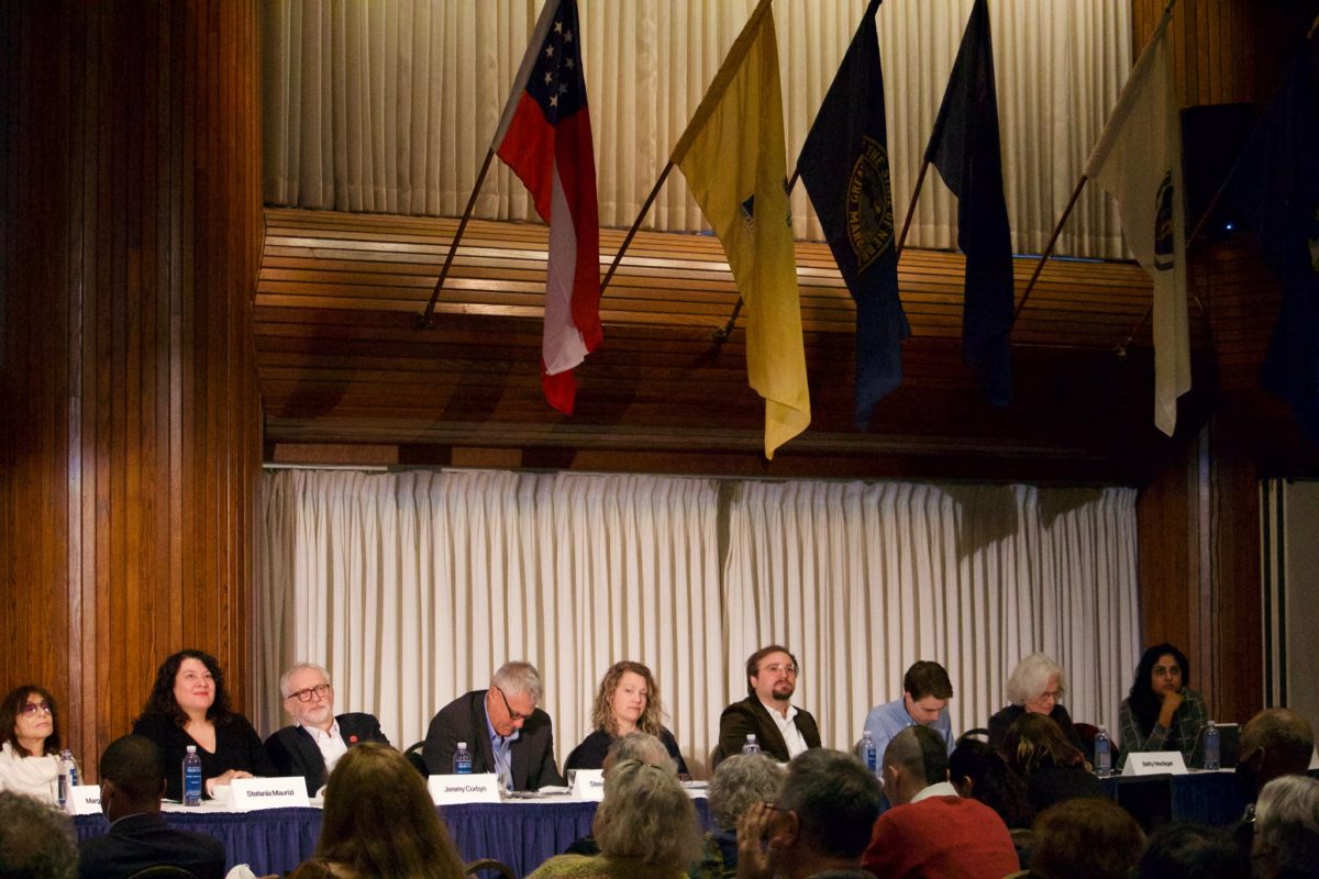 A photo of a panel of people at a table gathered for a Belmarsh Tribunal for Julian Assange event.