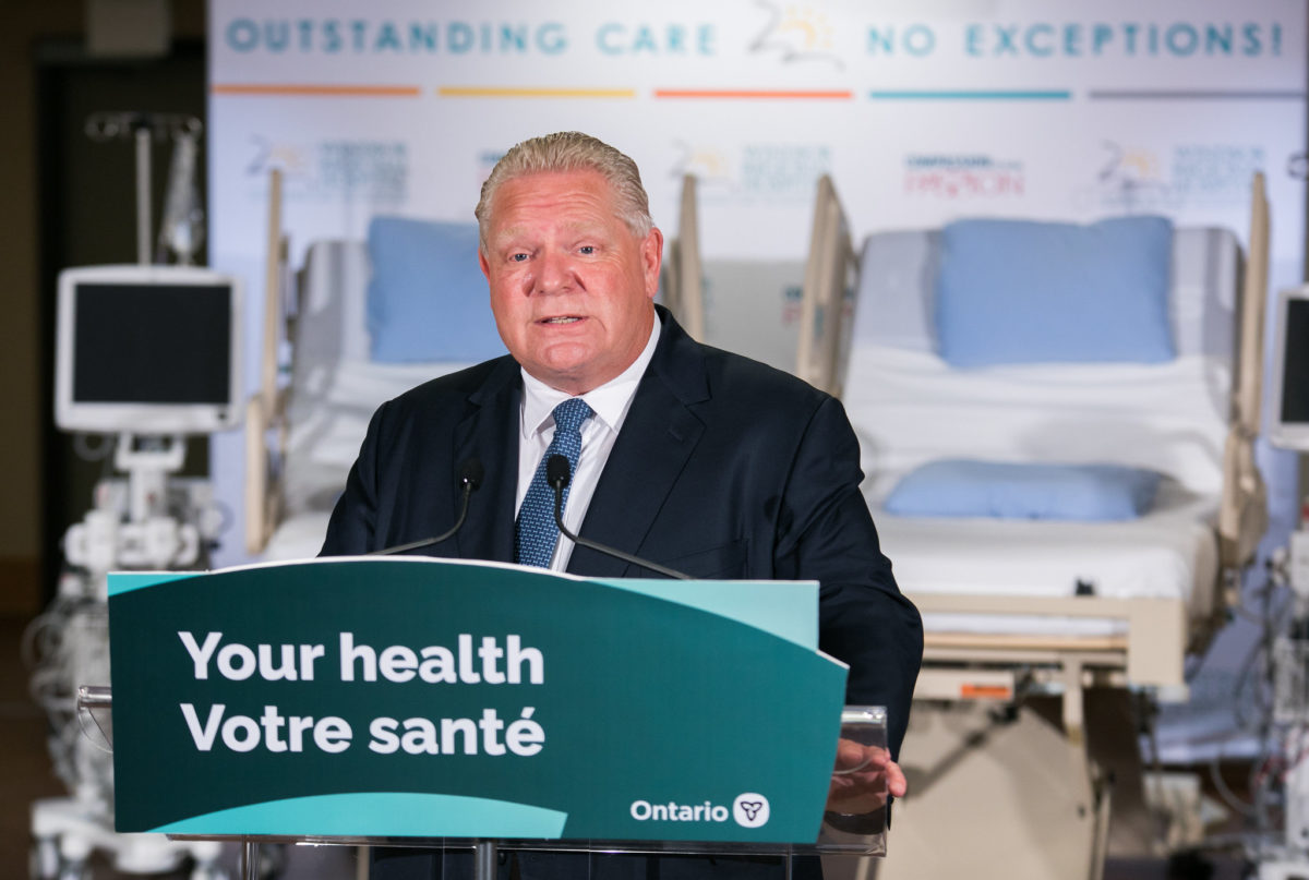 A photo of Ontario Premier Doug Ford in a hospital setting, as the province prepares to expand for-profit clinics.