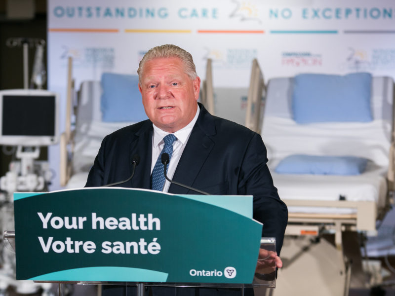 A photo of Ontario Premier Doug Ford in a hospital setting, as the province prepares to expand for-profit clinics.