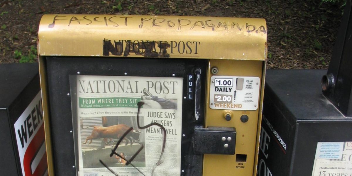 A vandalized National Post news box.