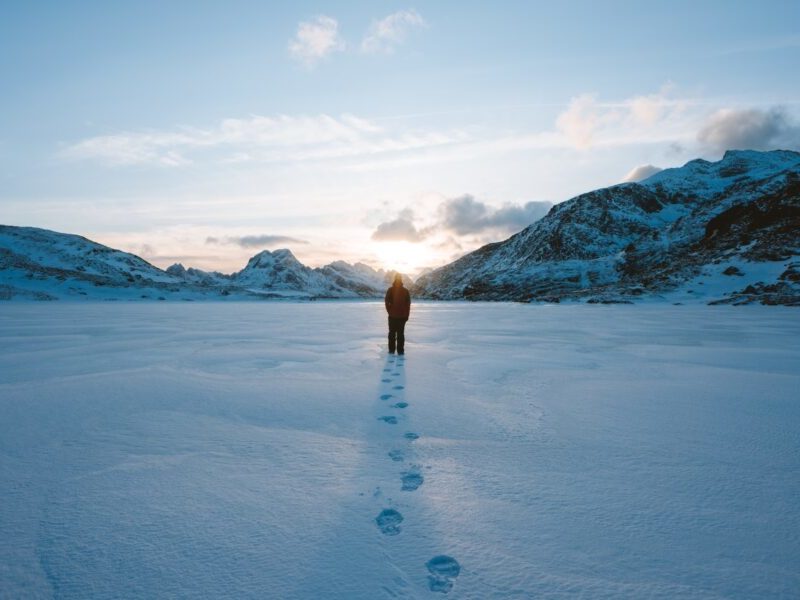 AN image of a person through deep snow in a valley