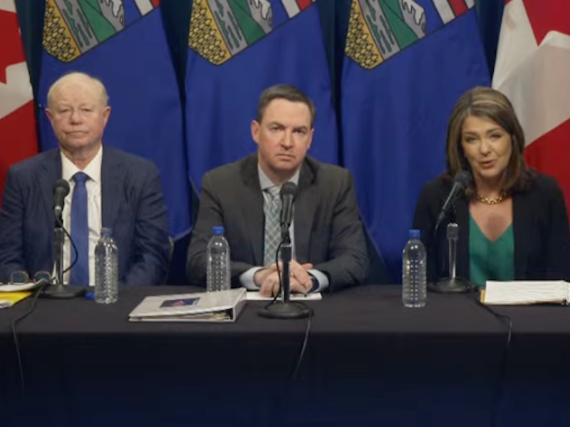 Dr. John Cowell, Health Minister Jason Copping, and Premier Danielle Smith at a news conference.