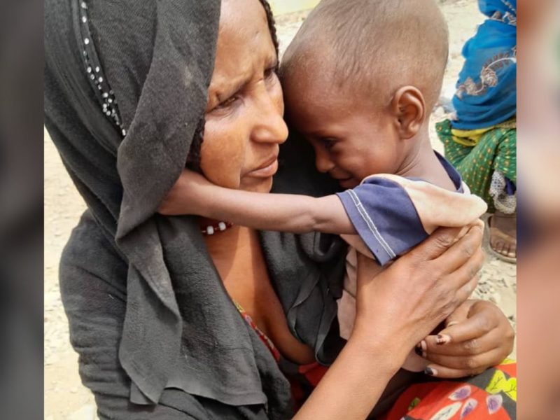 A displaced child from the Tigray region of Ethiopia and their mother.