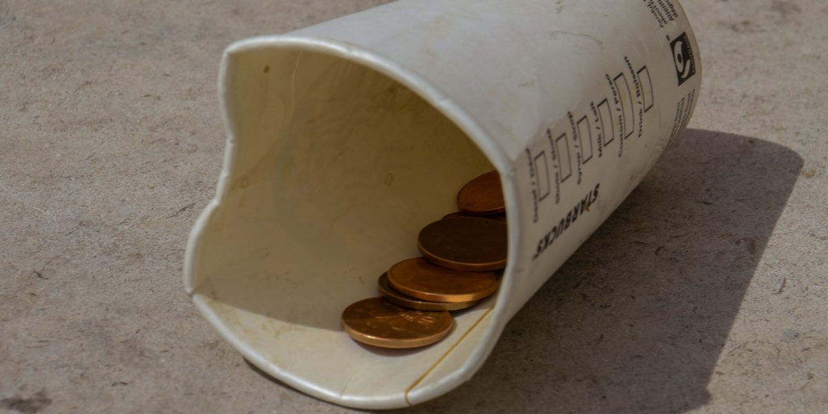 A cup used to collect coins.