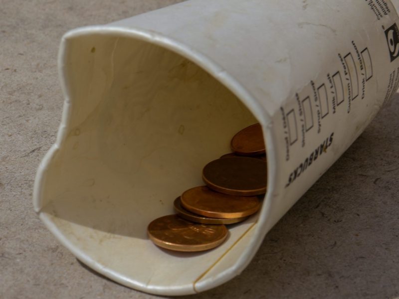 A cup used to collect coins.
