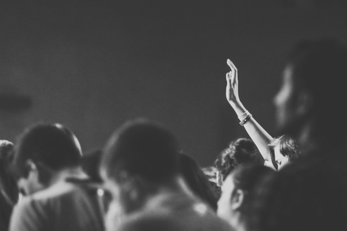 A photo of a person raising their hand in a group. ChatGPT presents a challenge to entrenched ways of teaching.