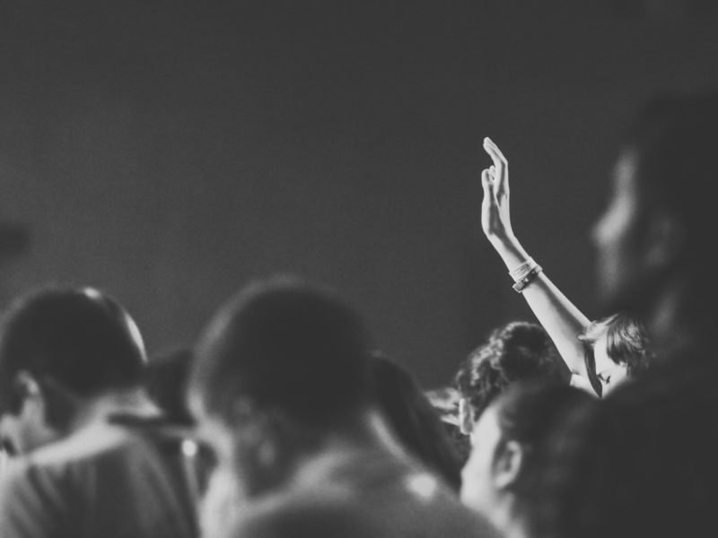 A photo of a person raising their hand in a group. ChatGPT presents a challenge to entrenched ways of teaching.