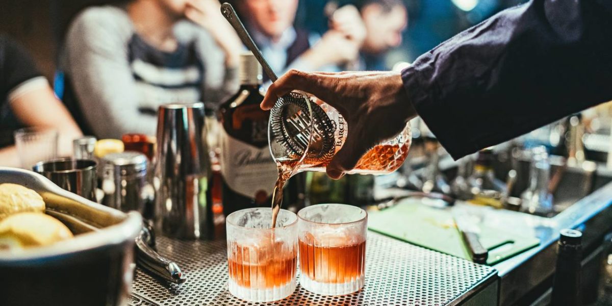 Alcoholic beverages being served at a bar.