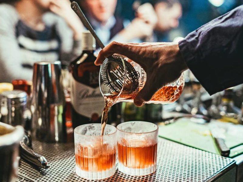 Alcoholic beverages being served at a bar.