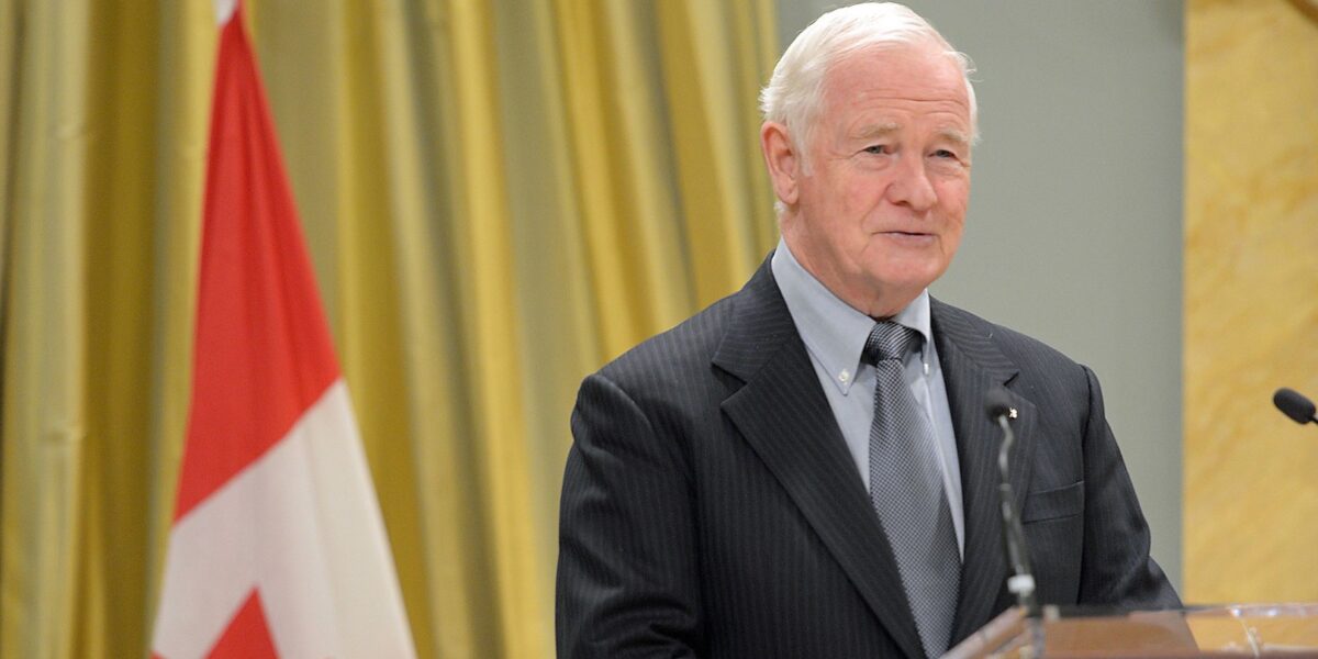 A photo of former governor general David Johnston standing at a podium.