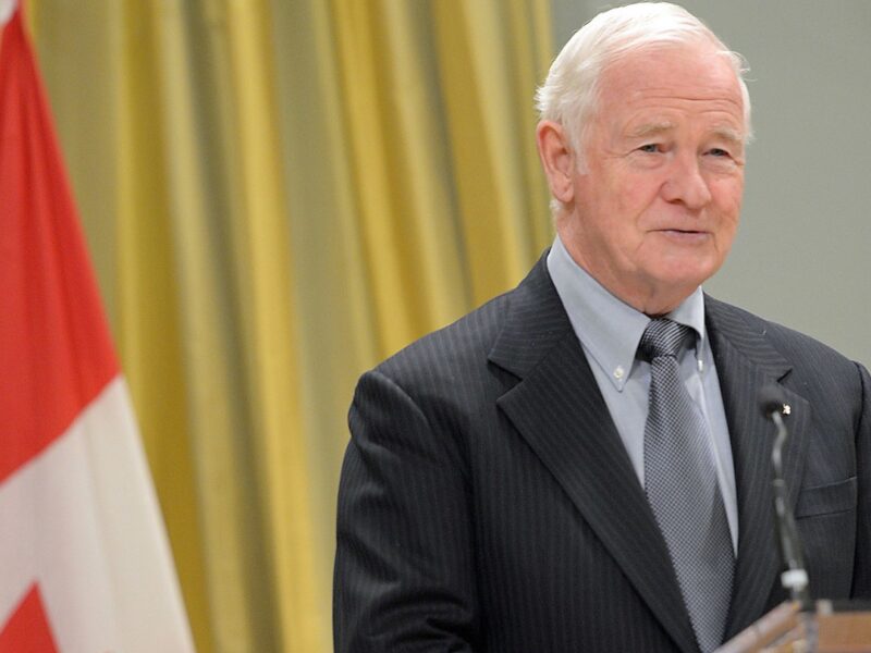 A photo of former governor general David Johnston standing at a podium.