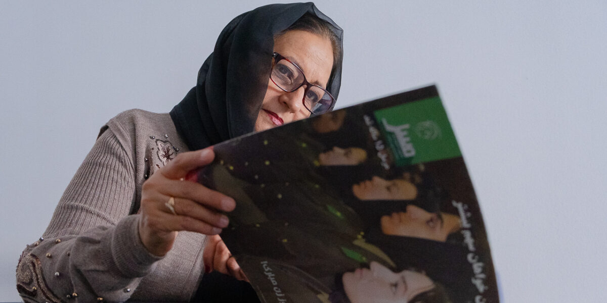 Amena Mayar flips through the pages of Mursal, a weekly publication centered around women's rights. For 17 years, Mayar was the chief editor of Mursal.