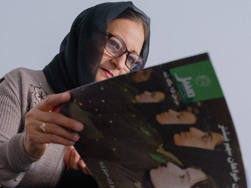 Amena Mayar flips through the pages of Mursal, a weekly publication centered around women's rights. For 17 years, Mayar was the chief editor of Mursal.