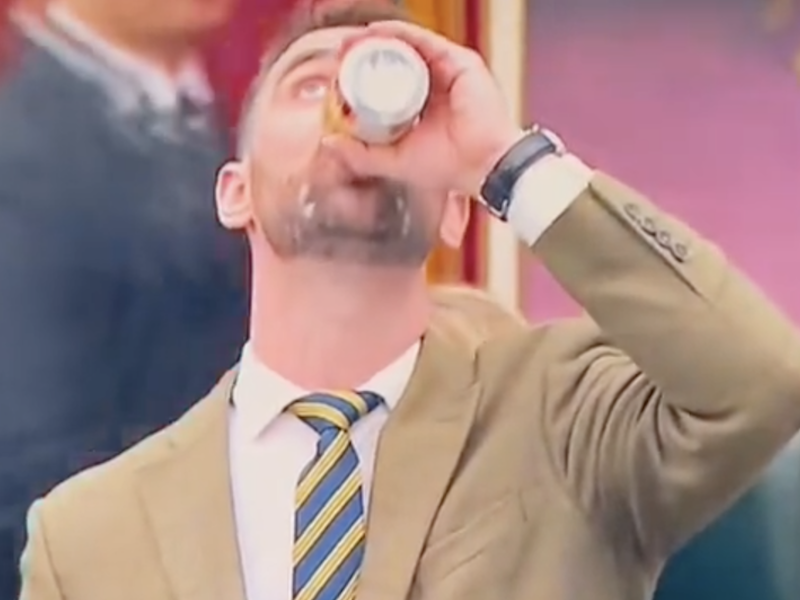 MLA Dan Williams chugs a beer in the Alberta Legislature.