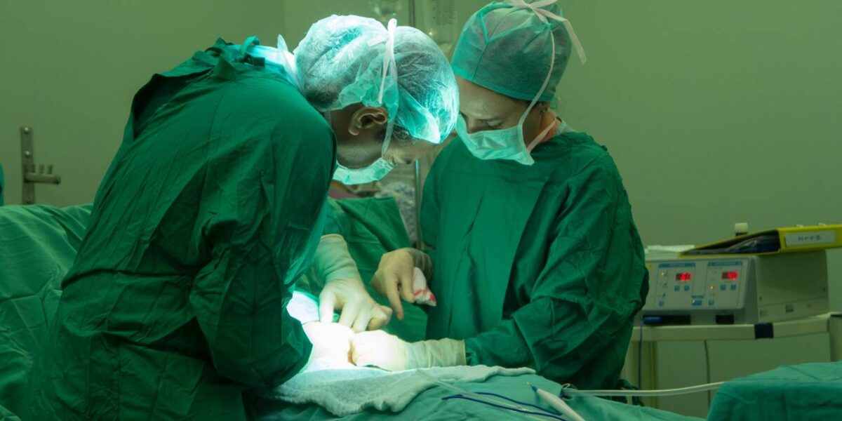 Doctors working on a patient in an operating room.