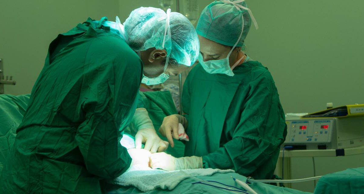 Doctors working on a patient in an operating room.